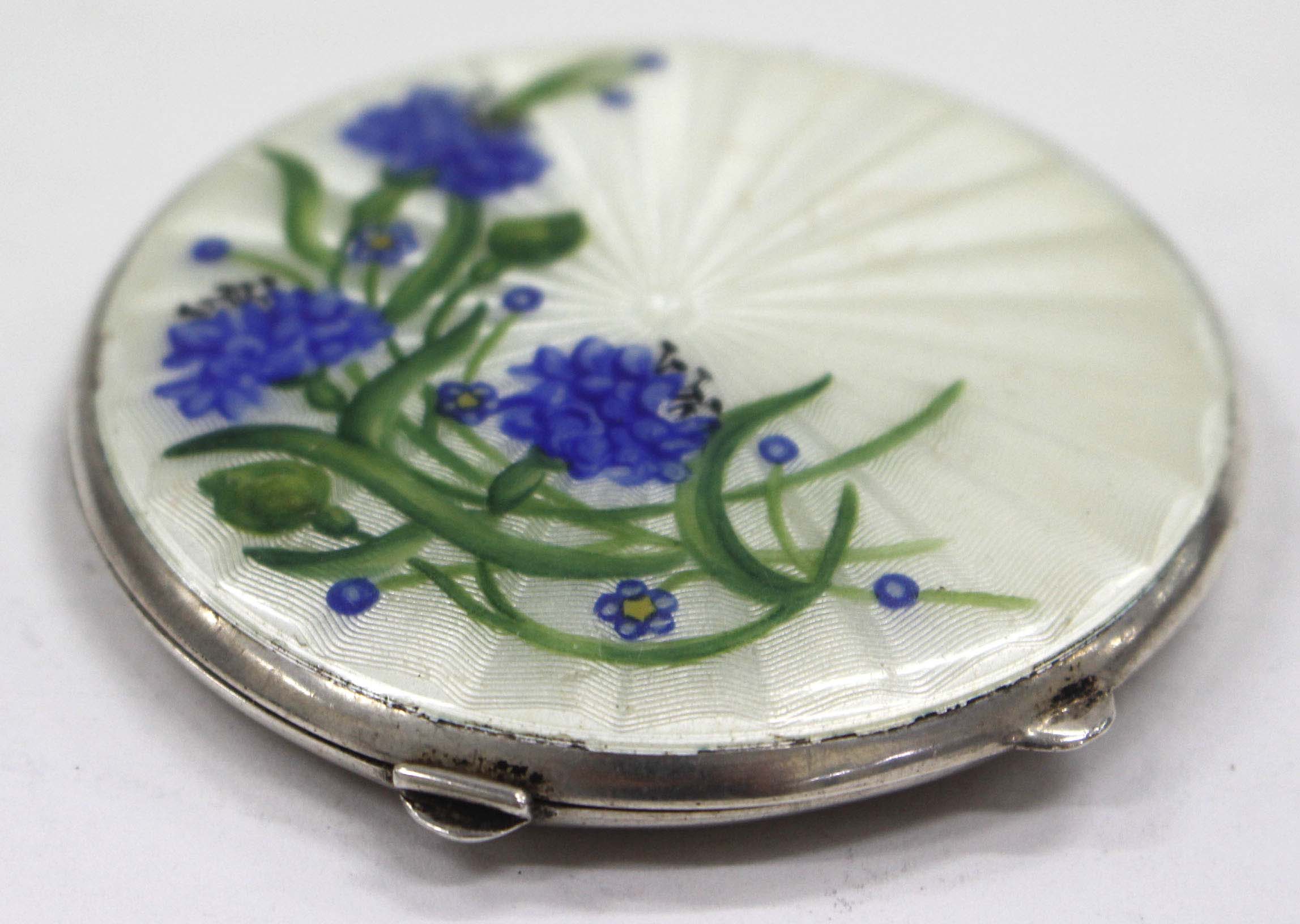 A MID 20TH CENTURY CIRCULAR SILVER ENAMEL DECORATED COMPACT painted with flowers to the front 6.