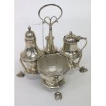 A SHEFFIELD SILVER CRUET SET AND STAND consisting of four pieces c.1912 on scroll pad shell feet,