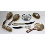 A SILVER BACK DRESSING TABLE SET to include four brushes and a hand mirror together with a pair of