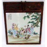 AN ORIENTAL RECTANGULAR PORCELAIN PLAQUE of figures seated beneath a tree, the plaque set within a