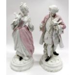 TWO 19TH CENTURY CONTINENTAL PORCELAIN FIGURINES of a lady and a gentleman, each in classical