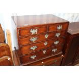 A 20TH CENTURY OAK FOUR DRAWER CHEST with foldout writing top