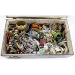 A PAINTED BLACK WOODEN TRUNK of costume jewellery including glass beads, bangles, trinket boxes,