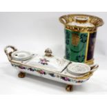 A PARIS PORCELAIN INK STAND of boat shape and with floral decoration 30cm wide together with a