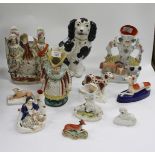 A GROUP OF VARIOUS STAFFORDSHIRE POTTERY consisting of models of dogs, a spill vase with a horse and