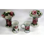 A PAIR OF WEMYSS WEAR VASES with rose decoration and of waisted cylindrical form with wavy rims,