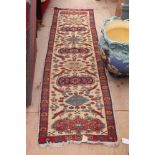 A RED GROUND RUNNER and further rug