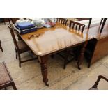 A MAHOGANY WIND OUT EXTENDING DINING TABLE on turned legs