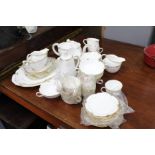 A ROYAL CROWN DERBY REGENCY PATTERN PART TEA SET with cups, saucers, a tea pot, two milk jugs, and a