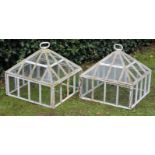 A PAIR OF WHITE PAINTED CAST IRON GARDEN CLOCHES, each with square stands with pyramidal covers,