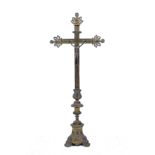 AN OLD CAST BRASS FRENCH CRUCIFIX with pierced scrolling decoration and triform plinth base with