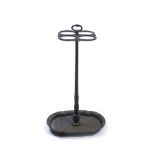 A VICTORIAN BLACK PAINTED CAST IRON UMBRELLA STAND with four sectional top and shaped base, 64cm