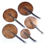 FIVE COPPER PAN LIDS with wrought iron handles