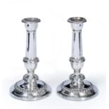 A PAIR OF GEORGE III SILVER TURNED CANDLESTICKS with gadrooned decoration and on a stepped base,