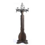 A LARGE CARVED OAK AND WROUGHT IRON LAMP STANDARD, the scrolling top with six lights, the post