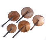 A SET OF FIVE COPPER PAN LIDS with wrought iron handles