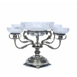 A SILVER PLATED TABLE CENTRE or caviar stand with central cut glass bowl on scrolling acanthus