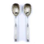 A PAIR OF VICTORIAN SILVER AND MOTHER OF PEARL HANDLED SERVING SPOONS with parcel gilt shell