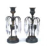 A PAIR OF FRENCH EMPIRE BRONZE CANDLESTICKS, the urn shaped sconces above hooped branches hung