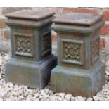 A PAIR OF CAST IRON SMALL PLINTHS with flower head decoration, each 20cm wide x 33cm high (2)