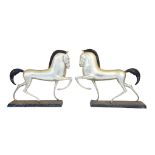 A PAIR OF CAST METAL ART DECO STYLE PRANCING HORSES, each on a rectangular plinth base and