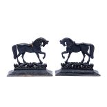 A PAIR OF CAST IRON DOOR PORTERS in the form of horses, each 31cm wide