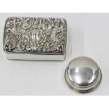 A SMALL RECTANGULAR SILVER BOX and a small silver pill box (2)