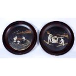 A PAIR OF JAPANESE LACQUERED CIRCULAR PLAQUES with mother of pearl decoration, 55cm diameter