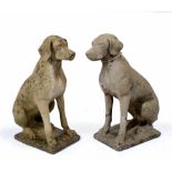 A PAIR OF WEATHERED CONCRETE GARDEN ORNAMENTS in the form of seated dogs, 69cm high