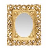 AN ITALIAN CARVED GILT FRAMED WALL MIRROR decorated with Cherubs 39cm wide x 47cm high