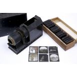 AN OLD MAGIC LANTERN in tin case together with a set of magic lantern slides in a box, some possibly