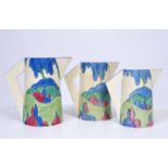 THREE CLARICE CLIFF BIZAARE CONICAL JUGS in the 'Rudyard' pattern, the tallest measures 18cm (3)