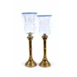 A PAIR OF RUSSIAN BRASS EJECTOR CANDLE STICKS, stamped with a mark beneath and date 1883 49cm high