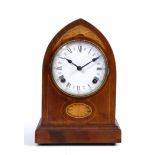 AN EDWARDIAN LANCET CASE STRIKING MANTLE CLOCK, 32cm high; and a mahogany revolving bookcase, 45cm