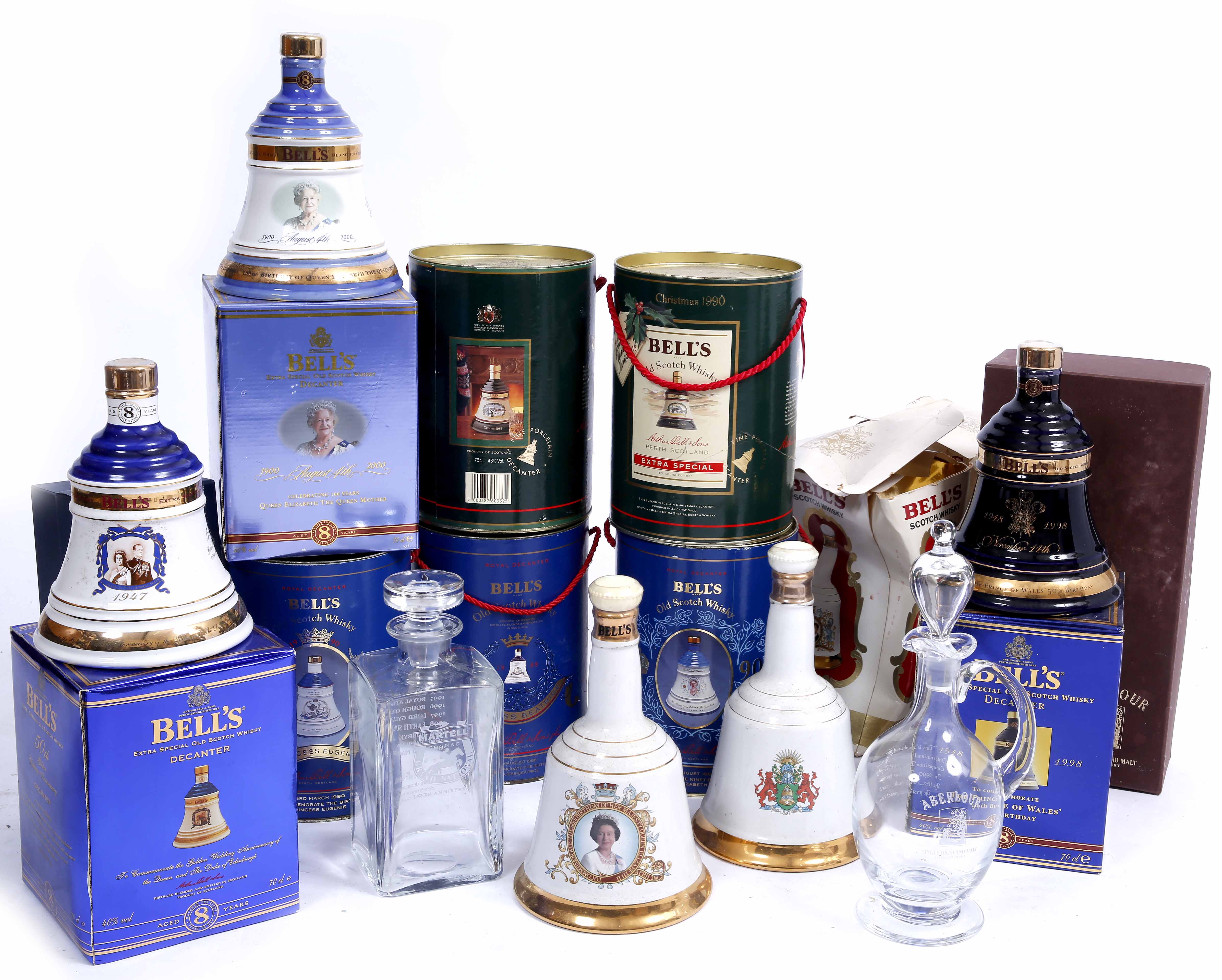 A GROUP OF VARIOUS BELLS BOTTLE DECANTERS from various years with 8 year old whisky within