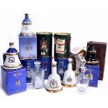 A GROUP OF VARIOUS BELLS BOTTLE DECANTERS from various years with 8 year old whisky within