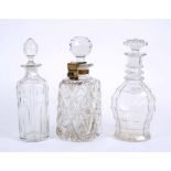 THREE GLASS DECANTERS including a locked example by 'Mannis, patent' measures 27cm high (3)