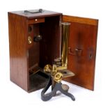 A LATE 19TH / EARLY 20TH CENTURY MICROSCOPE in mahogany case, 30cm high