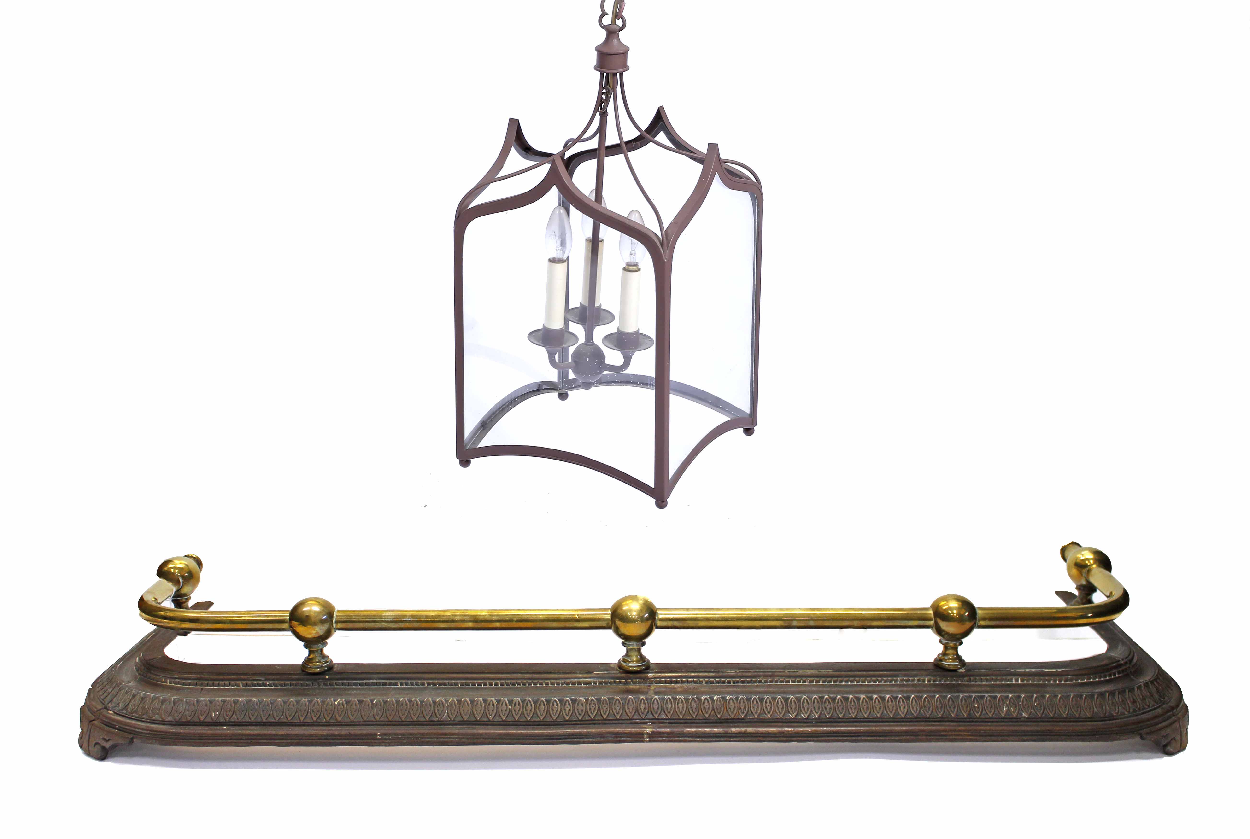 A VICTORIAN BRASS AND STEEL FIRE SURROUND, 120cm long; and a Gothic style metal frame hall