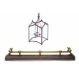 A VICTORIAN BRASS AND STEEL FIRE SURROUND, 120cm long; and a Gothic style metal frame hall