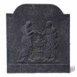 AN ANTIQUE CAST IRON FIRE BACK with arching top decorated with two classical figures, 66cm wide x