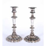 A PAIR OF LATE GEORGIAN AND SILVER PLATED CANDLE STICKS 23cm high