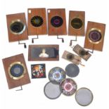 A GROUP OF 19TH CENTURY AUTOMATON MAGIC LANTERN SLIDES many with kaleidoscope type decoration