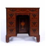 A GEORGE III MAHOGANY KNEE HOLE DESK with inlaid classical decoration to the top and drawer