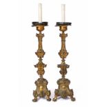 A PAIR OF 19TH CENTURY CONTINENTAL PRESSED METAL TRIFORM LARGE CANDLESTICKS converted for electric