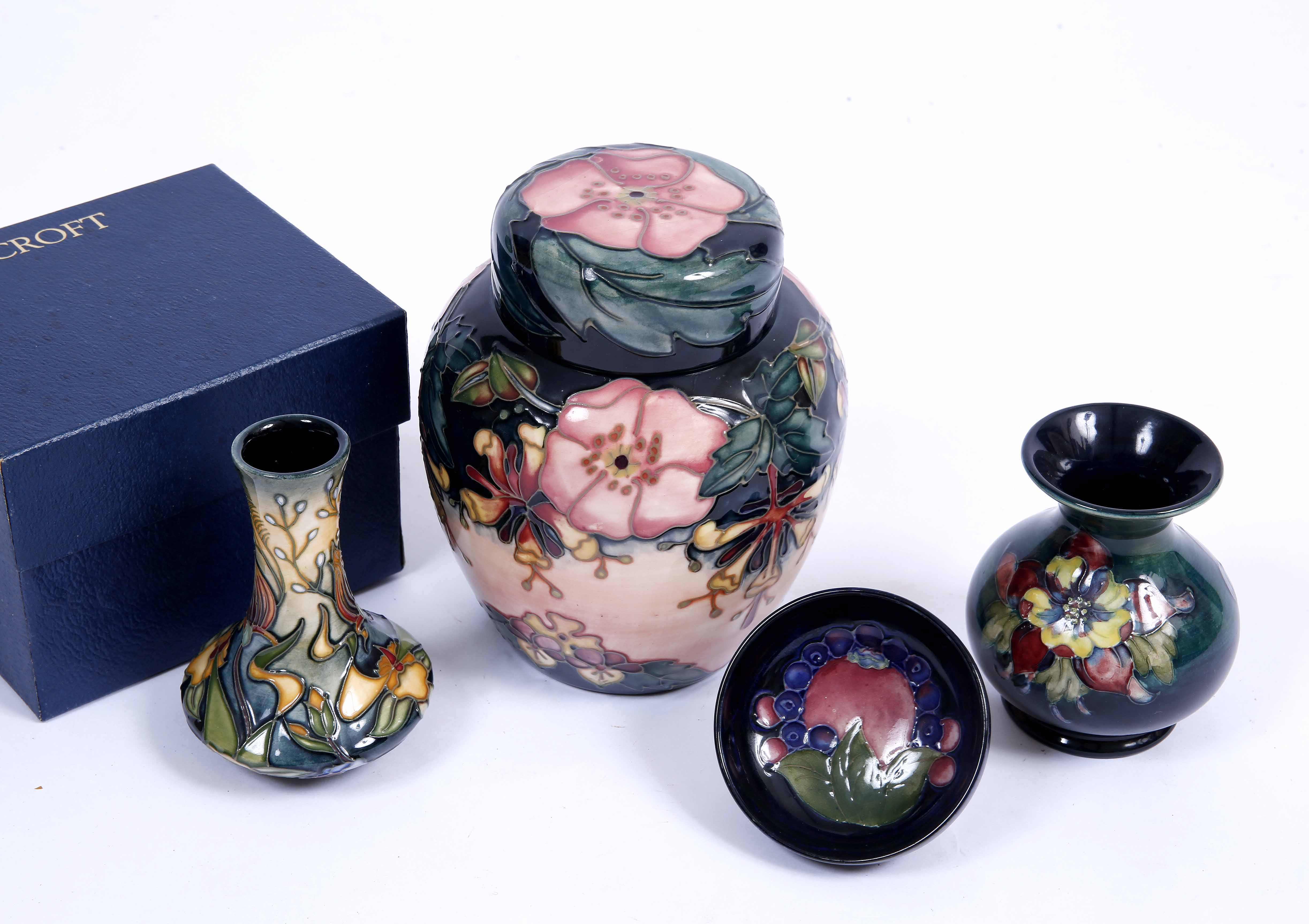 AN OLD MOORCROFT BOTTLE VASE 9.5cm high together with a pin dish, a further bottle vase and a jar