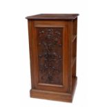 A VICTORIAN OAK PEDESTAL BOOKCASE with carved panel to the front and adjustable shelves to either