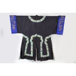 A Chinese robe early 20th Century of black ground decoration, embroidered panel decorated with