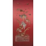 A chinese silk work picture of red ground, embroidered with birds and butterflies above a pond,