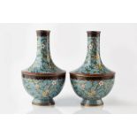 A pair of Chinese cloisonne vases early 20th Century of blue ground with blossom designs, 24cm high